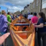 Club members waling Torrent Gig Rowing Boat down onto the harbour , Isles of Scilly